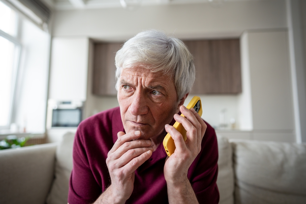 Tired distrust shocked retiree man in discomfort listening to unknown caller making dubious requests